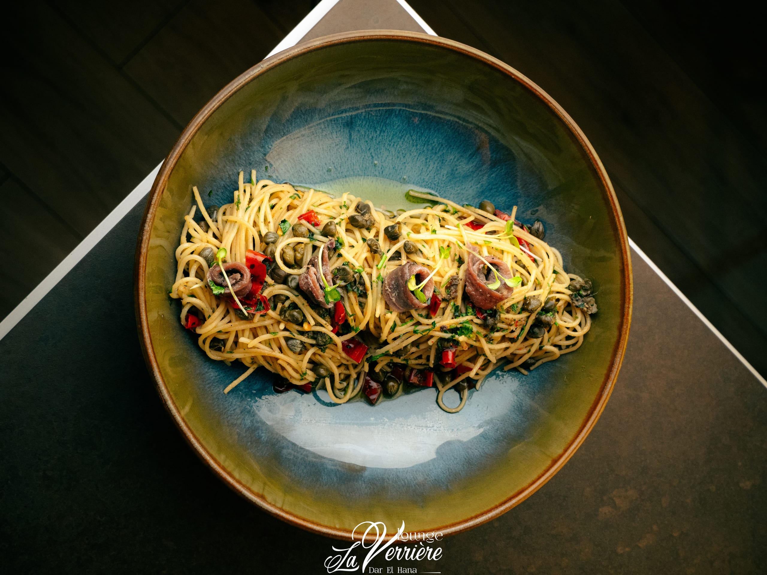 Spaghetti with anchovies and capers, overhead